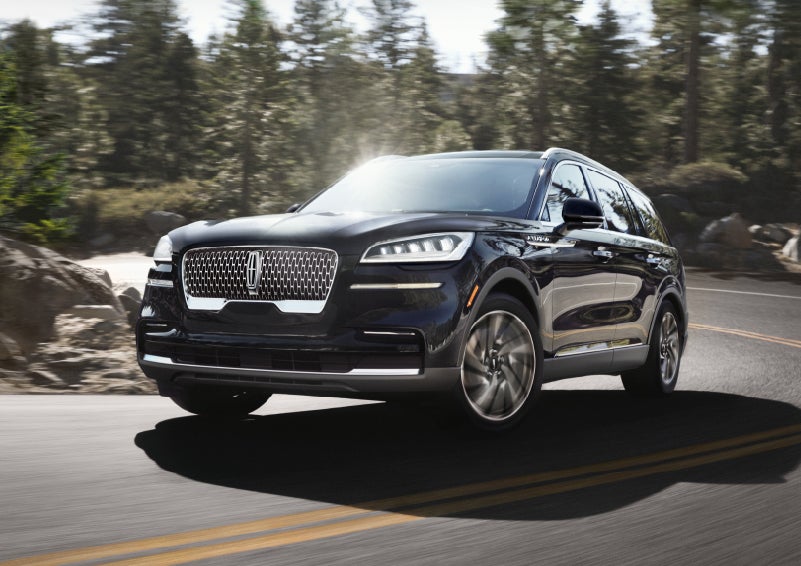 A Lincoln Aviator® SUV is being driven on a winding mountain road | Brinson Lincoln of Athens in Athens TX