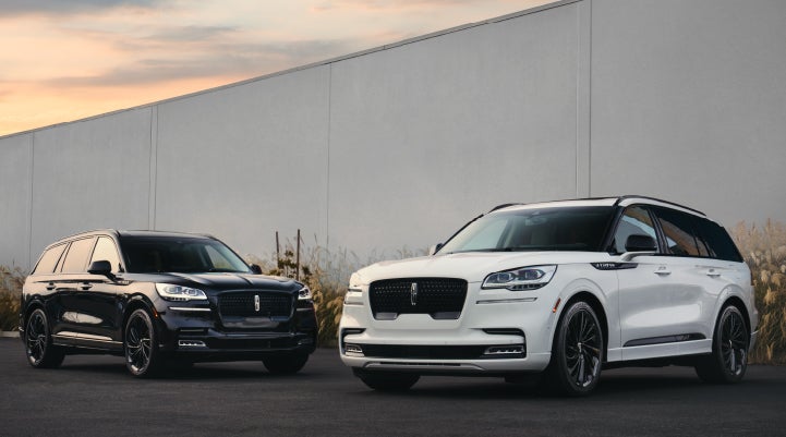 Two Lincoln Aviator® SUVs are shown with the available Jet Appearance Package | Brinson Lincoln of Athens in Athens TX